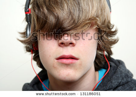 stock-photo-teenager-listening-to-music-hiding-behind-his-hair-131186051