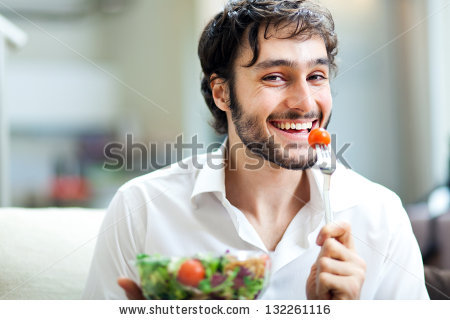 stock-photo-young-man-eating-a-healthy-salad-132261116